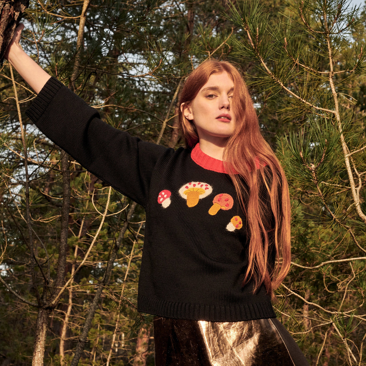 Black merino wool sweater with hand-crocheted mushrooms and red collar