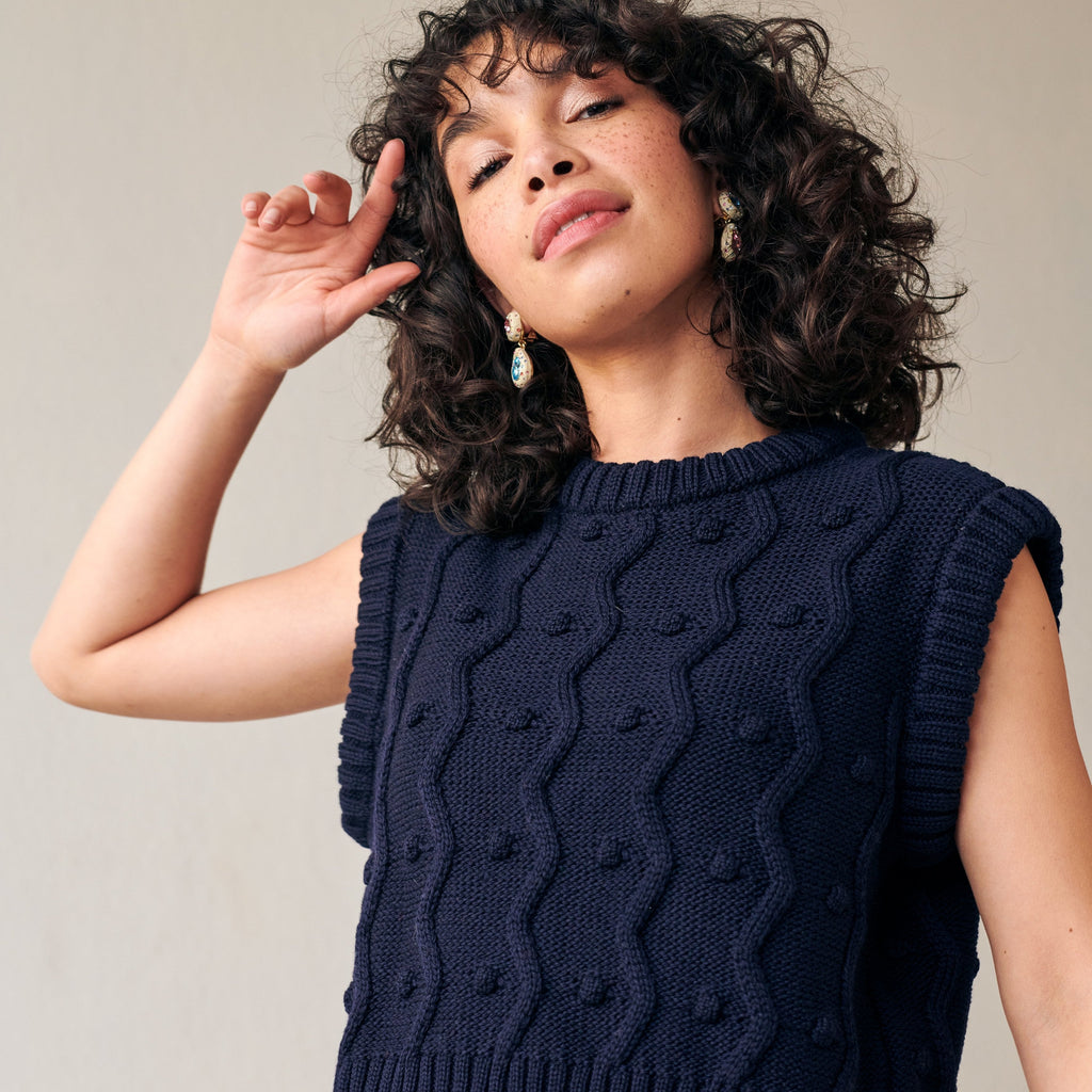 Navy merino wool sweater vest with zig-zags and mini pom-poms