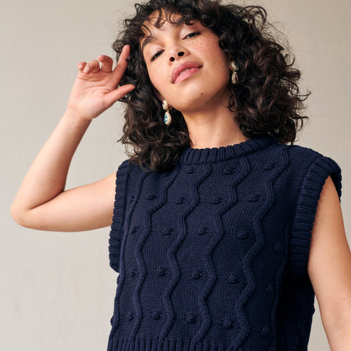 Navy merino wool sweater vest with zig-zags and mini pom-poms