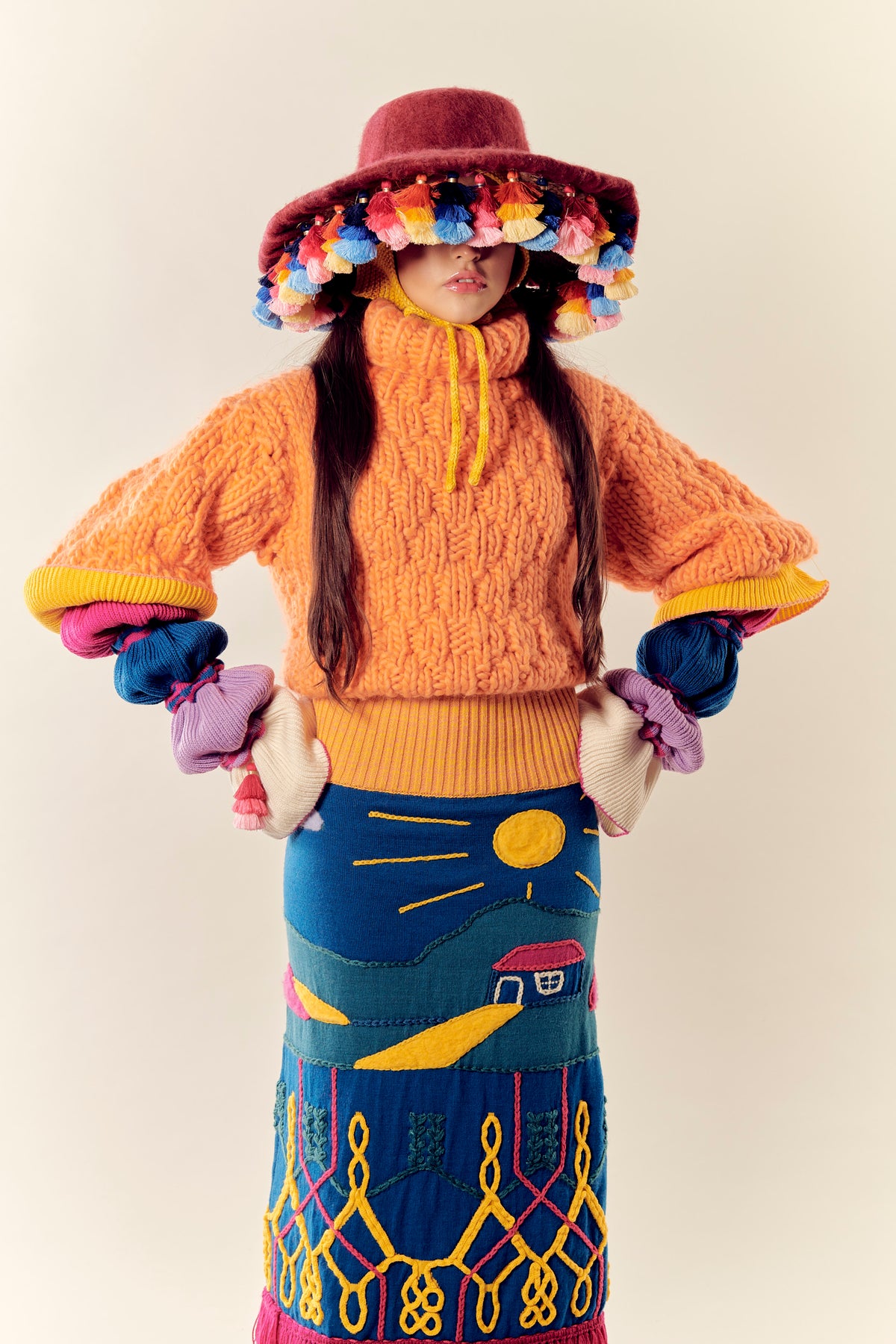 Mediodía orange hand-knit wool sweater by Matríaca Studio